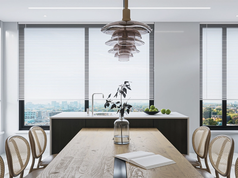 White roller blinds on large windows in a modern dining and kitchen space